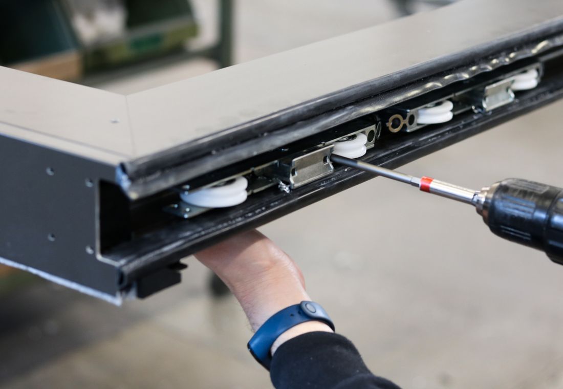 Assembling aluminium sliding-window hardware in the Kimber workshop